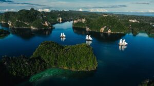 Luxury Phinisi yacht sailing in Indonesian waters, offered by Pacific High.