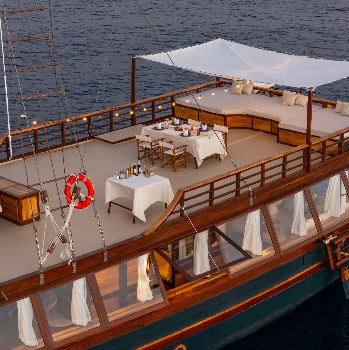 Pacific High luxury private yacht Senja with 2 guests enjoying cocktails at sunset
